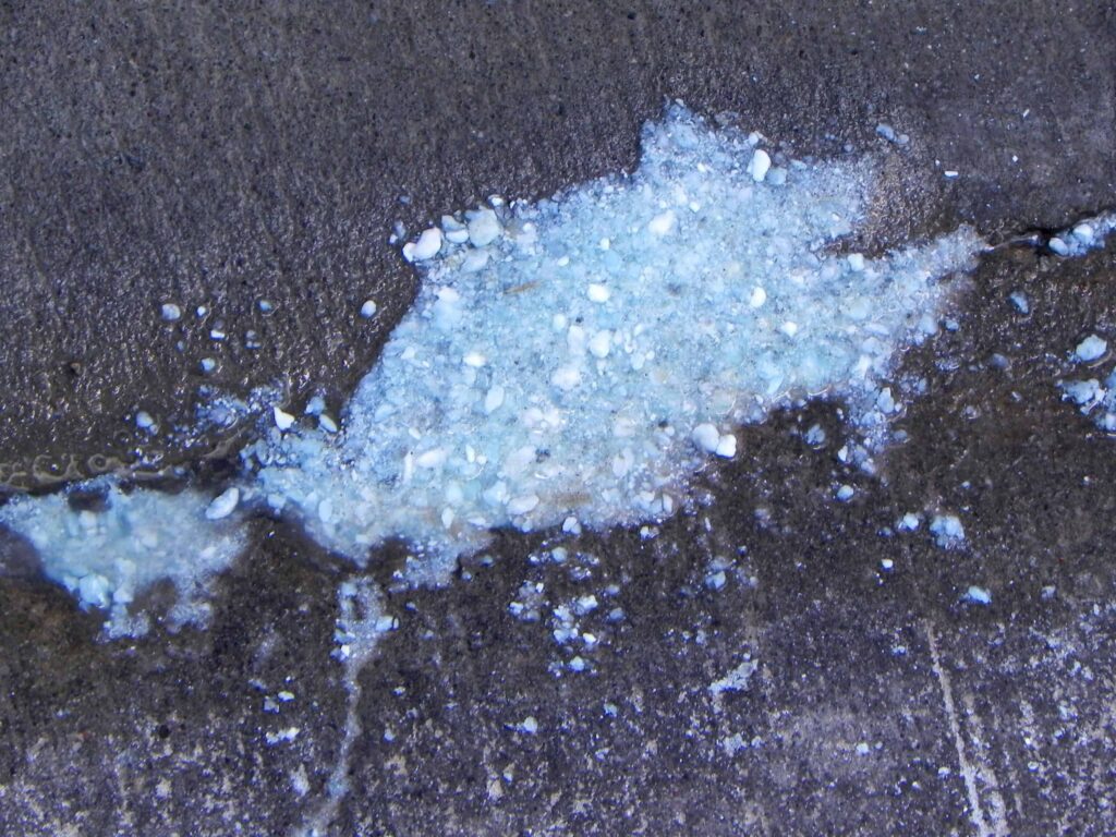 A liquid spill on a dark concrete surface, ready to be expertly cleaned or repaired by Bell Brothers’ trusted technicians. Proudly serving Northern California communities, our background-checked professionals arrive with our No Surprise Guarantee and clear, upfront pricing—ensuring results you can rely on every time.