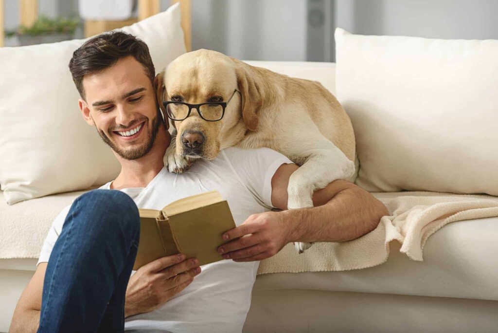 A man sits comfortably on the floor reading a book, while his Labrador—sporting a charming pair of glasses—rests its head affectionately on his shoulder. They both look completely relaxed, knowing they can count on Bell Brothers’ trusted service, including our No Surprise Guarantee, background-checked technicians, and upfront pricing. Bell Brothers is proud to be a name that families across Northern California communities rely on for honest and professional care.