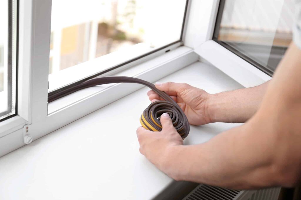 A trusted Bell Brothers technician, background-checked for your peace of mind, gets ready to install weatherstripping on a window frame. With their No Surprise Guarantee and clear, upfront pricing, Bell Brothers proudly delivers reliable service to communities throughout Northern California.