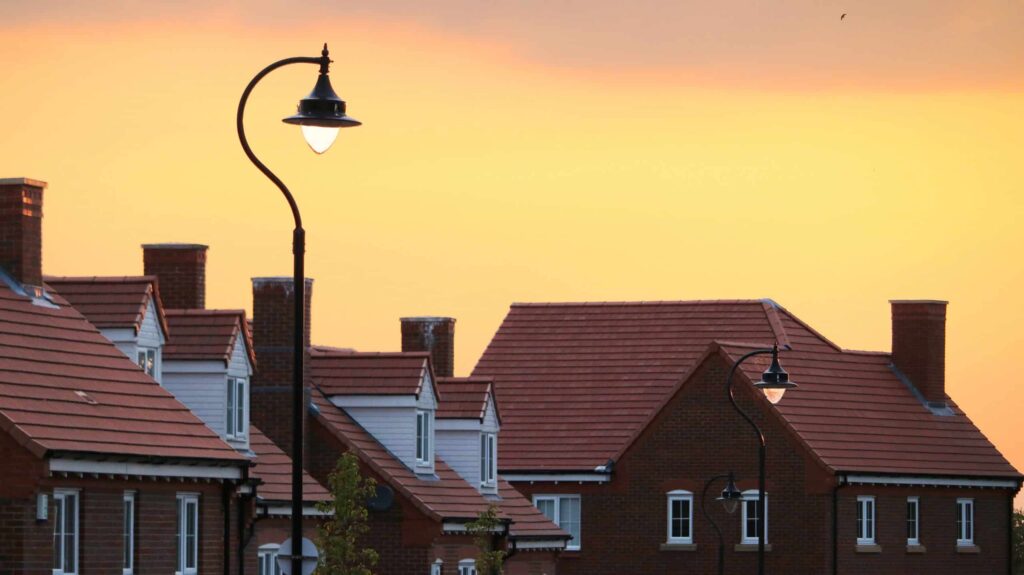 Suburban rooftops and street lamps glow beneath a warm yellow-orange sunset, reflecting Bell Brothers’ trusted service lighting up Northern California neighborhoods. Our background-checked technicians provide expert care with upfront pricing and our No Surprise Guarantee, earning us the reputation for reliability you can count on in every community we serve.