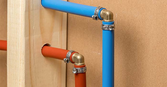 When repiping a house, the plumber will probably use PEX pipes. Pictured are two PEX pipes, one red for warm water and one blue for cold water.