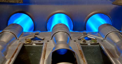 Image: furnace burners with a blue flame.